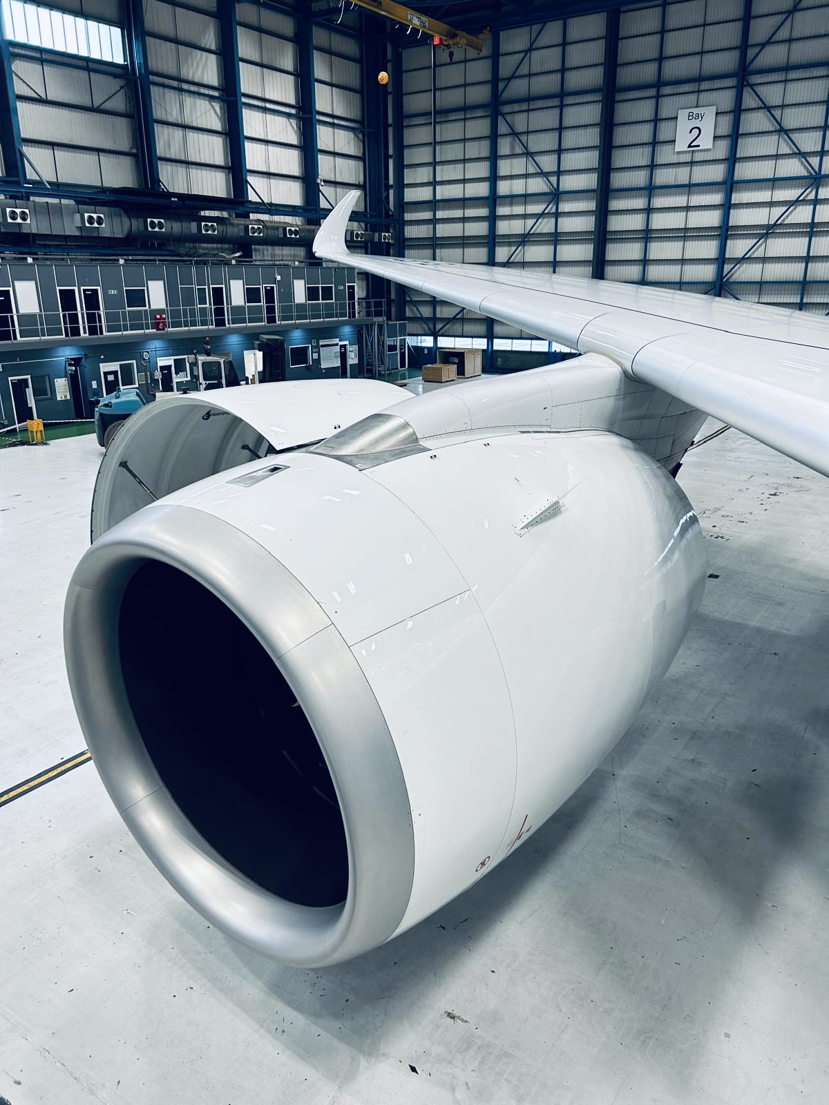 Adams MRO Solutions Image Image of airplane engine inside a hangar.